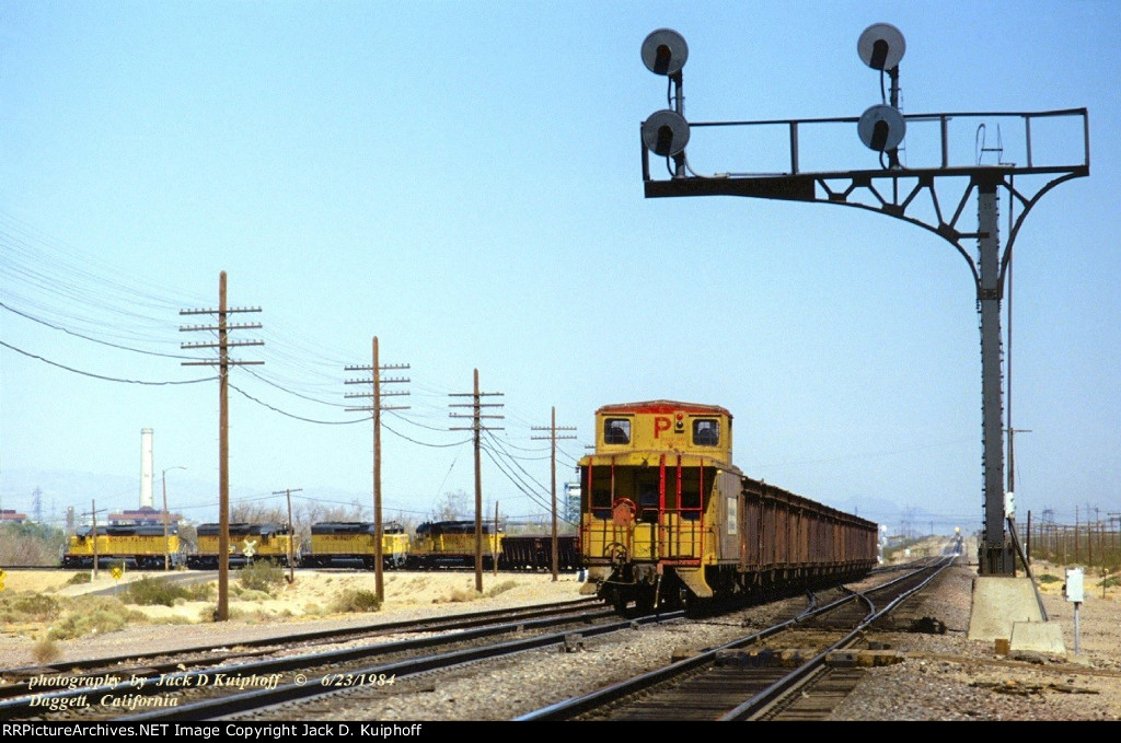UP, Union Pacific SD40-2s 3647-3787-3227-3534, with a eastbound ore train swing off the AT&SF, and on to the UP at Daggett, California. June 23, 1984. 